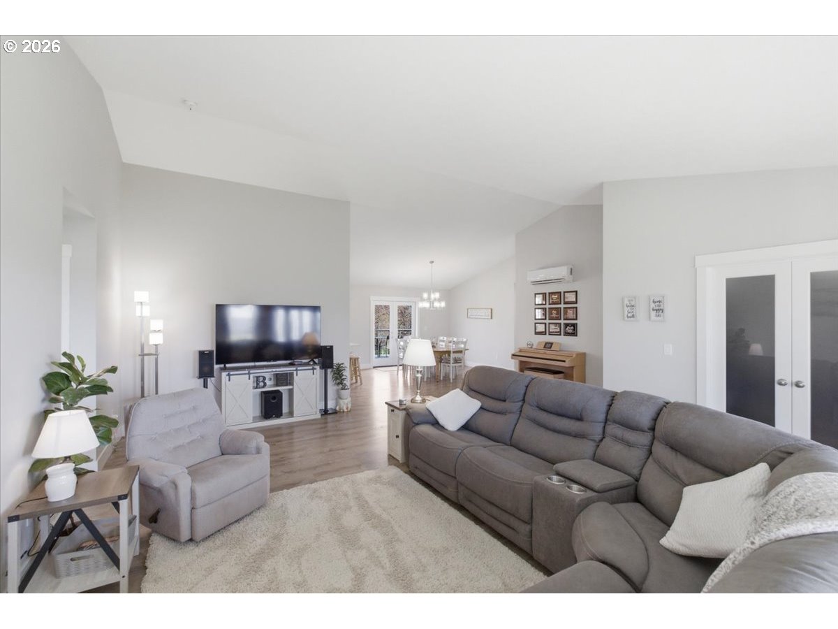 12008 Duck Inn Road Northeast Gervais, OR 97026 - Photo 11 of 48 a living room with furniture and a flat screen tv