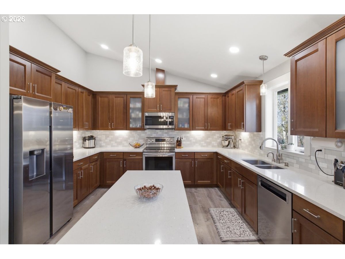 12008 Duck Inn Road Northeast Gervais, OR 97026 - Photo 16 of 48 a kitchen with a sink stainless steel appliances and cabinets