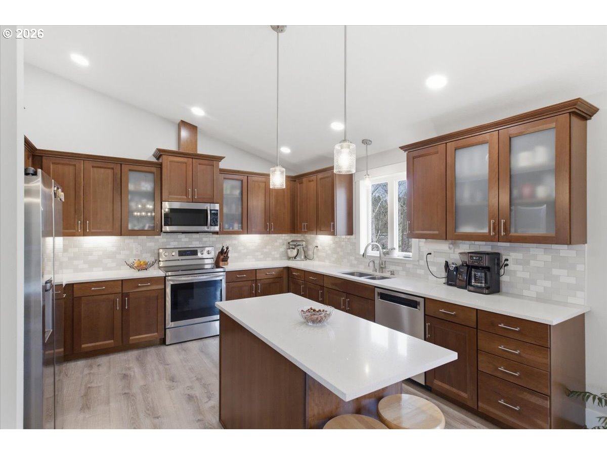 12008 Duck Inn Road Northeast Gervais, OR 97026 - Photo 17 of 48 a kitchen with stainless steel appliances a sink stove and refrigerator