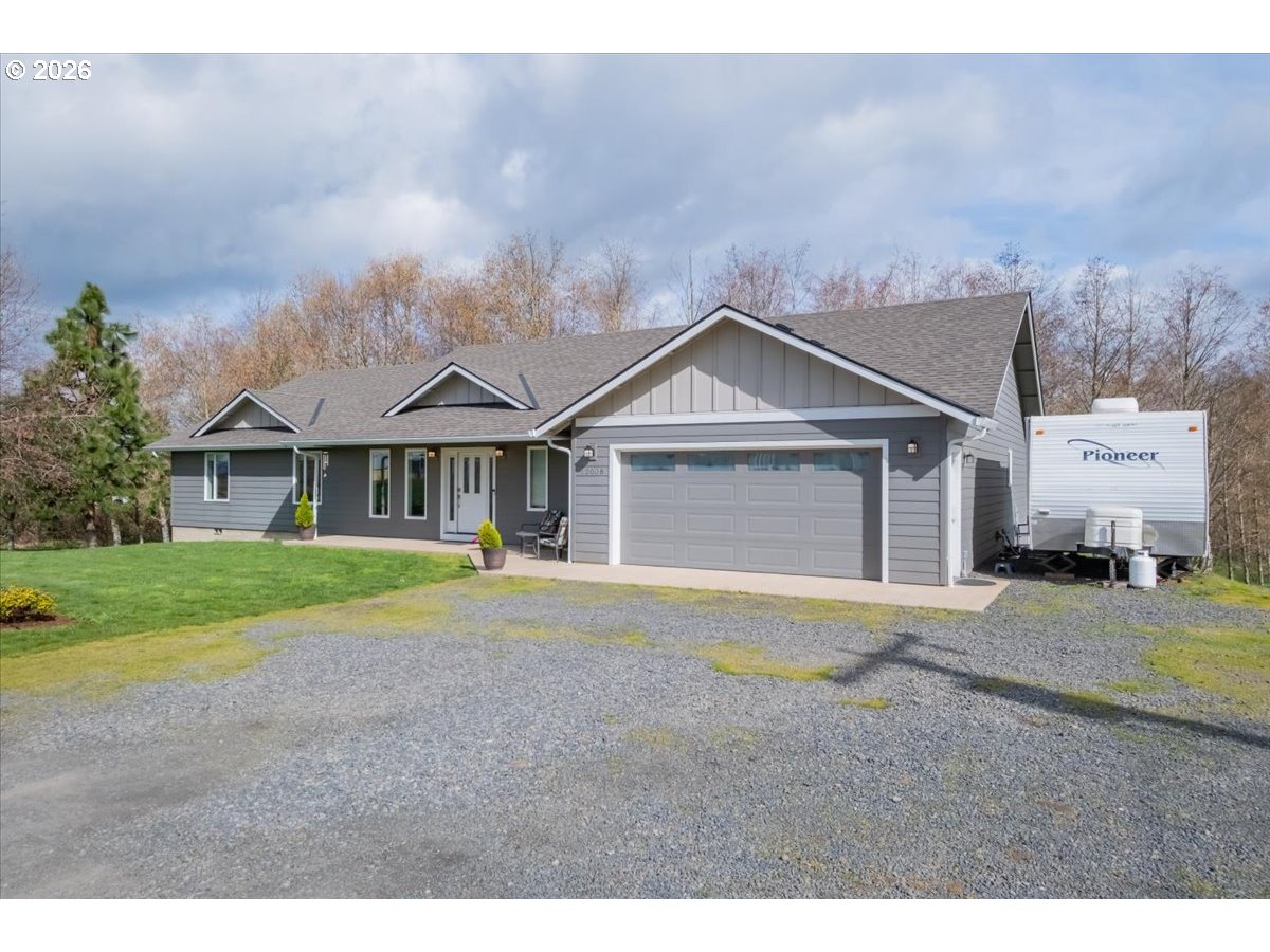 12008 Duck Inn Road Northeast Gervais, OR 97026 - Photo 2 of 48 a front view of a house with a yard and garage