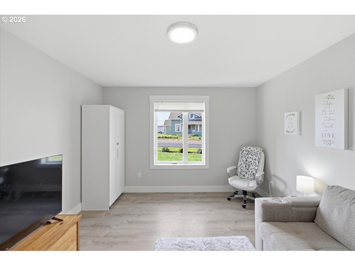 12008 Duck Inn Road Northeast Gervais, OR 97026 - Photo 28 of 48 a living room with furniture a flat screen tv and a window