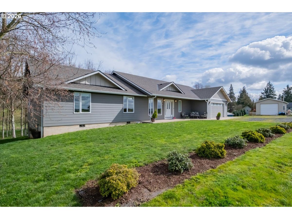 12008 Duck Inn Road Northeast Gervais, OR 97026 - Photo 3 of 48 a front view of a house with a yard