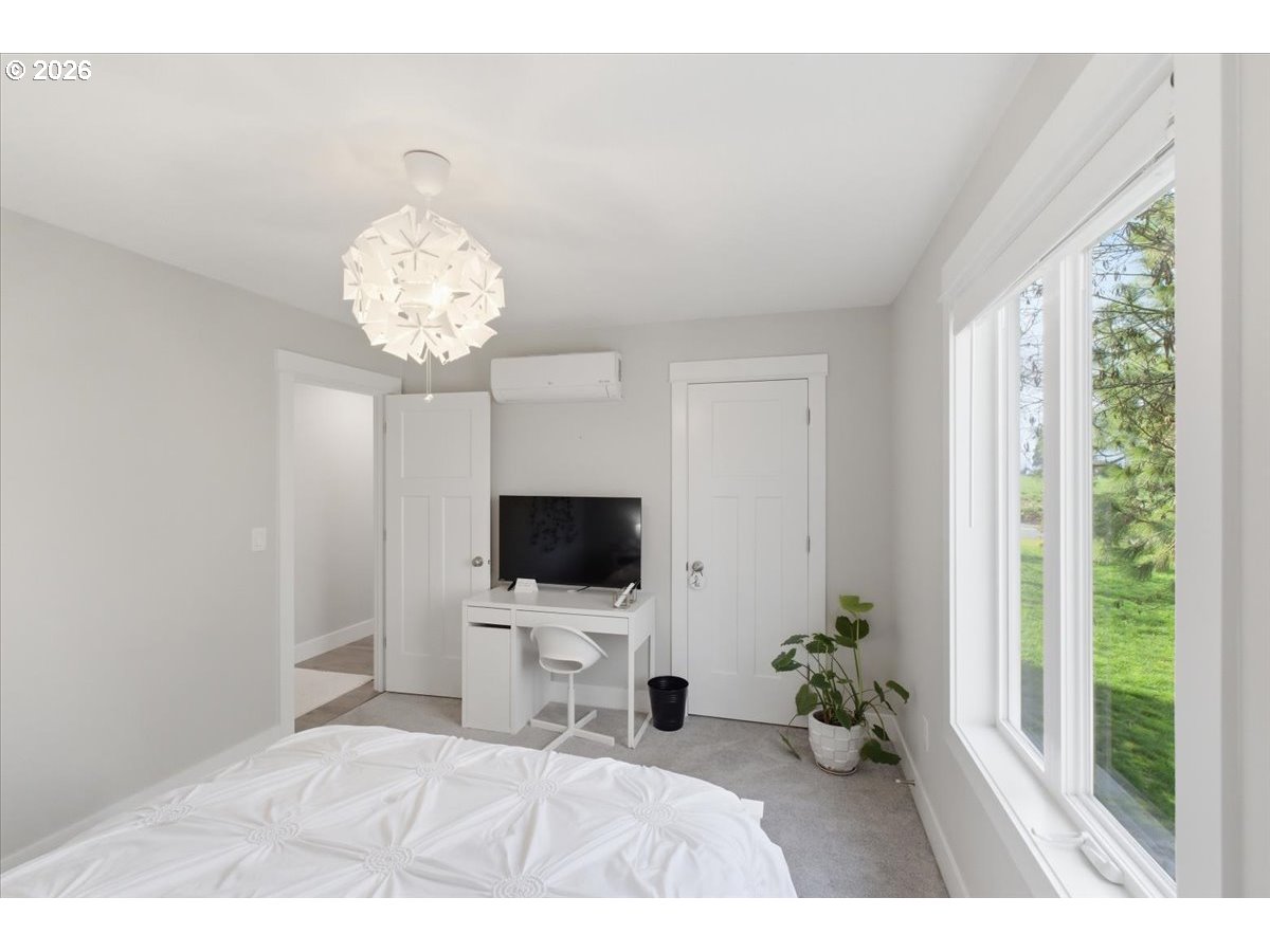 12008 Duck Inn Road Northeast Gervais, OR 97026 - Photo 35 of 48 a bedroom with a bed and a flat screen tv