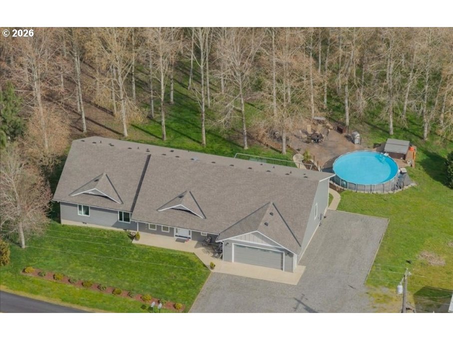 12008 Duck Inn Road Northeast Gervais, OR 97026 - Photo 5 of 48 a view of a white house with a big yard and large trees