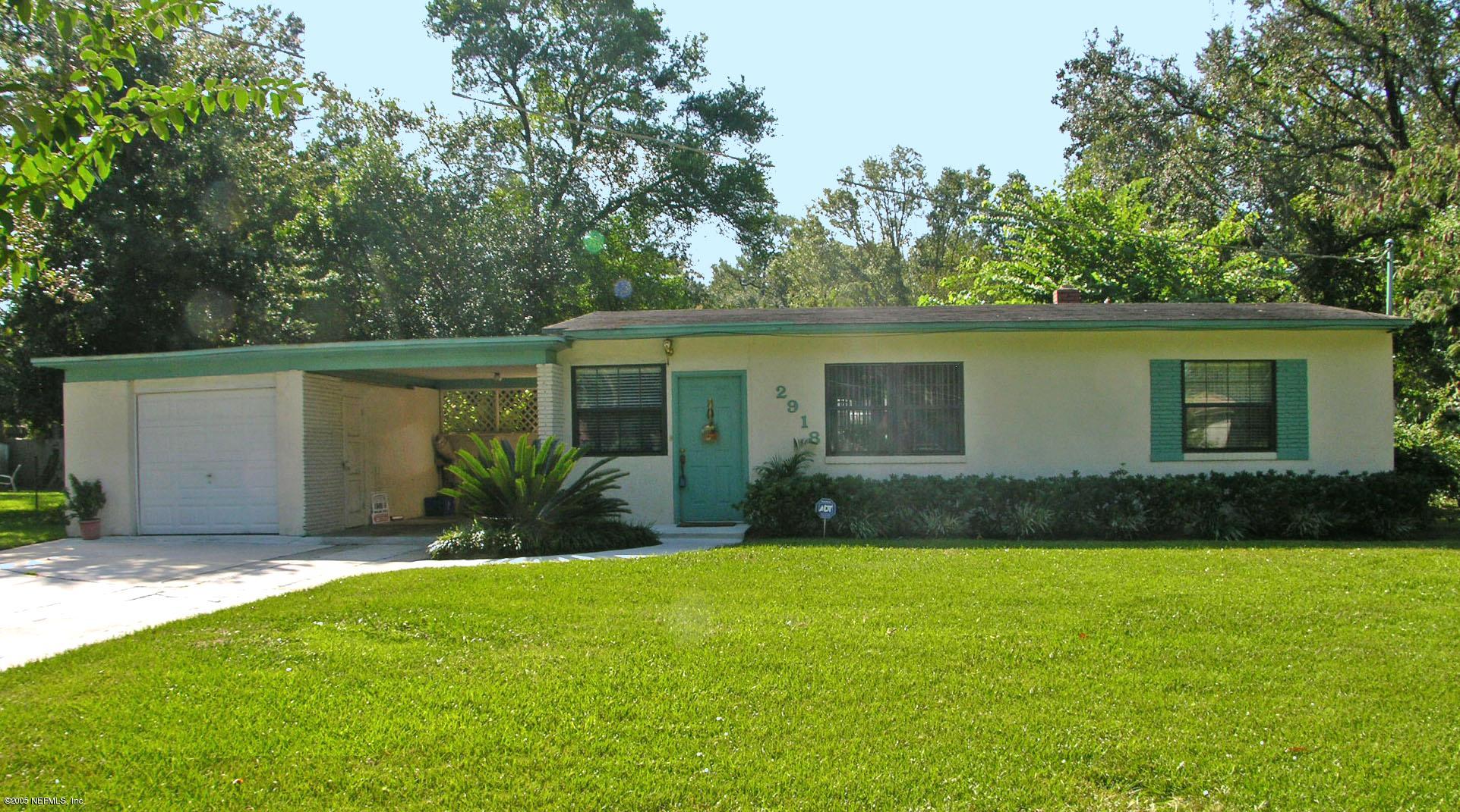 a view of a house with a yard and plants