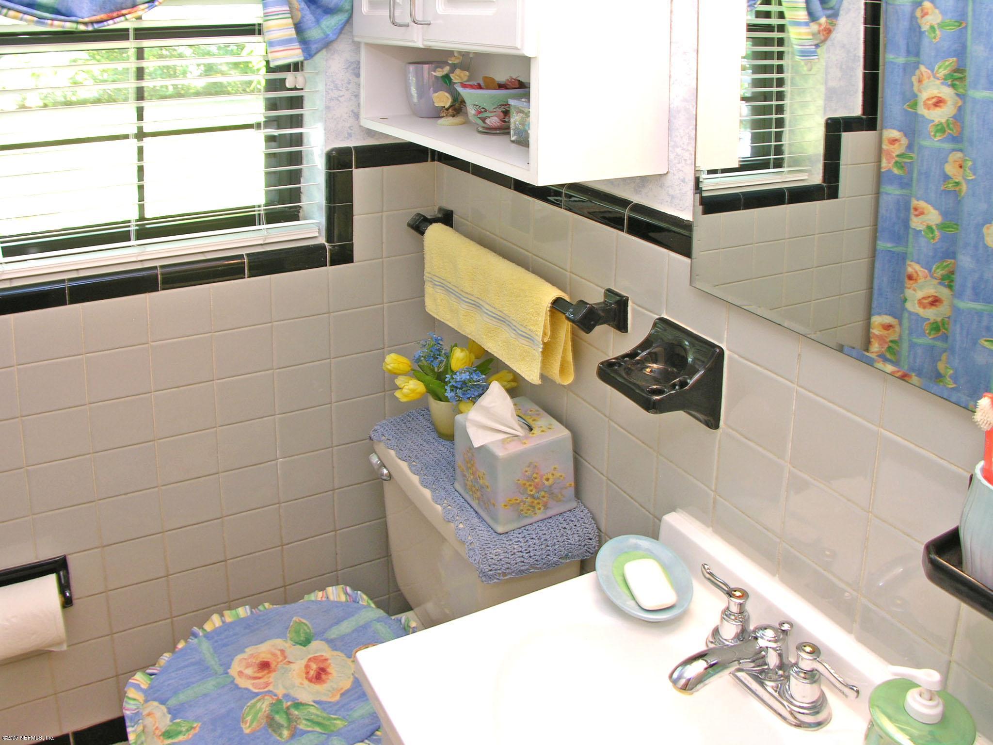 2918 Christopher Road Jacksonville, FL 32217 - Photo 7 of 10 a bathroom with a sink a toilet and a shower curtain