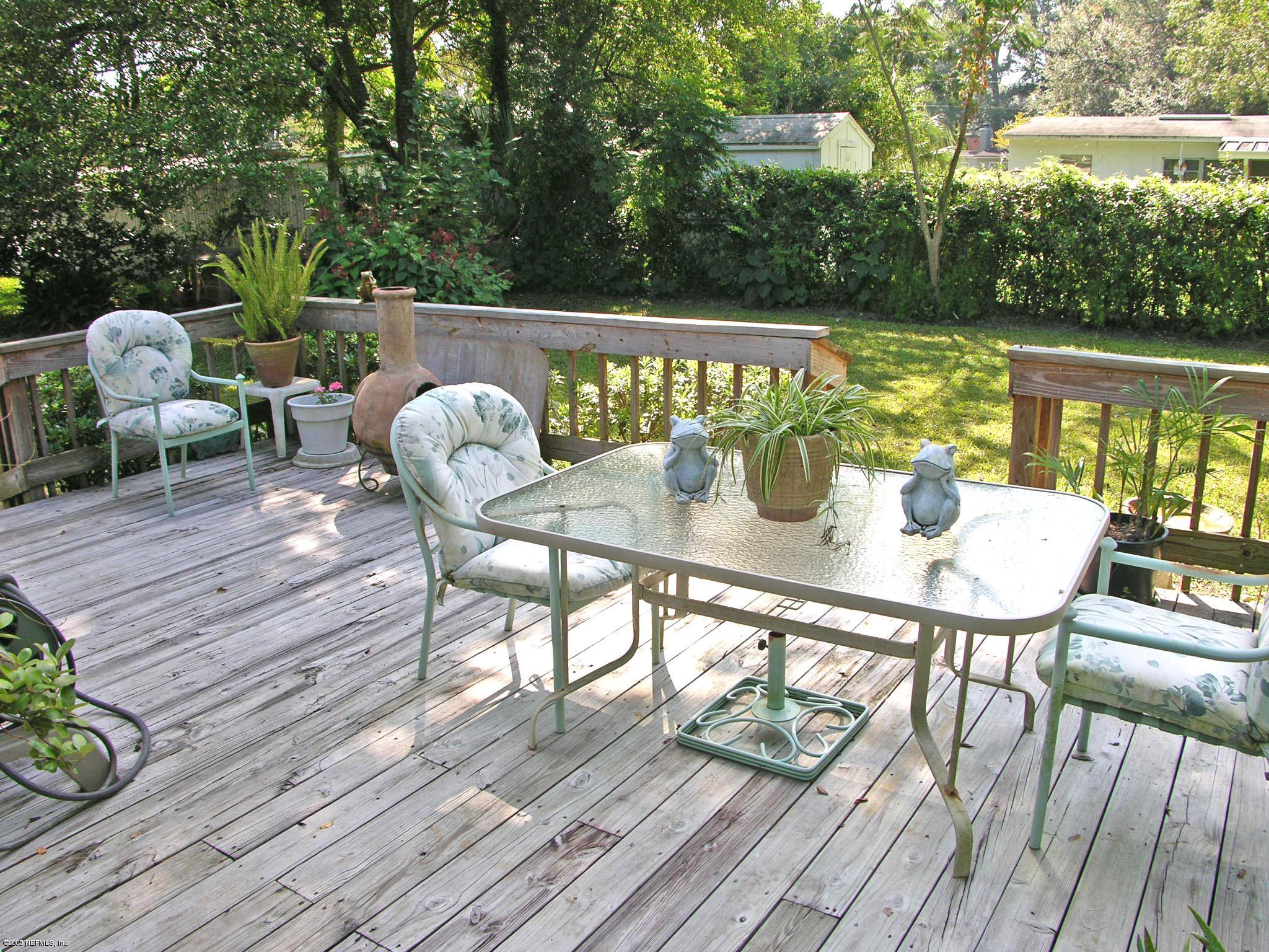 2918 Christopher Road Jacksonville, FL 32217 - Photo 9 of 10 a balcony with wooden floor table and chairs