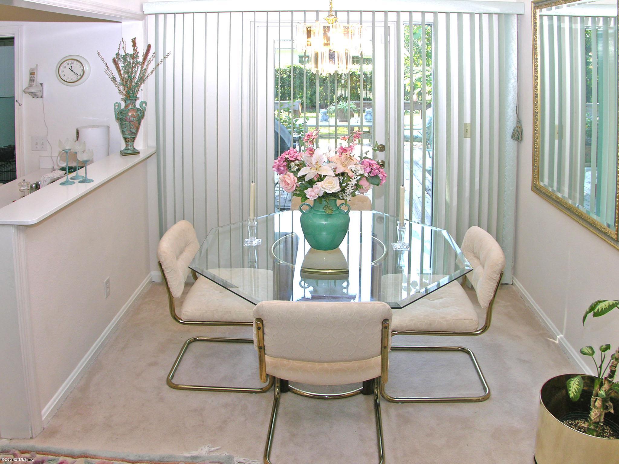2918 Christopher Road Jacksonville, FL 32217 - Photo 10 of 10 a dining room with furniture and flowers