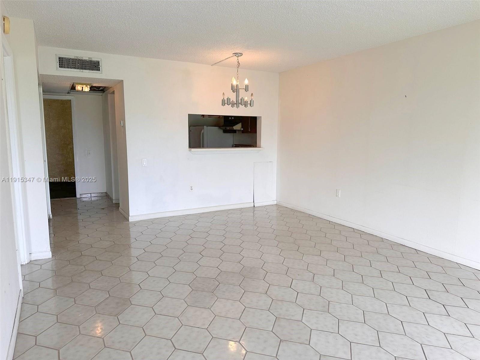 9090 Lime Bay Boulevard, Unit 106 Tamarac, FL 33321 - Photo 12 of 37 a view of a livingroom with an empty space