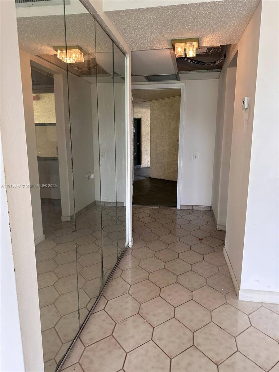 9090 Lime Bay Boulevard, Unit 106 Tamarac, FL 33321 - Photo 15 of 37 a view of a hallway