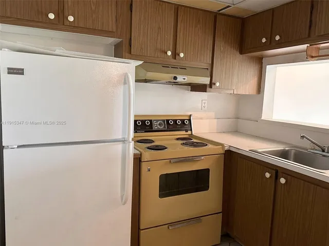 a view of a kitchen with washer and dryer