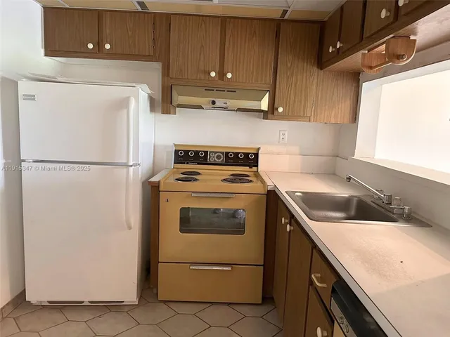 a white refrigerator freezer sitting inside of a kitchen