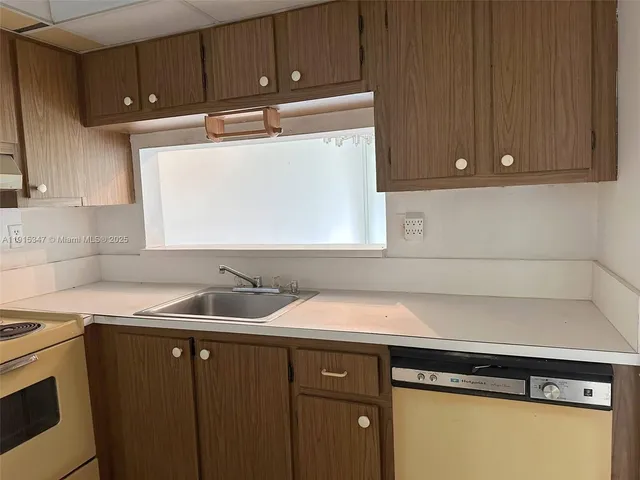 a kitchen with a sink and cabinets