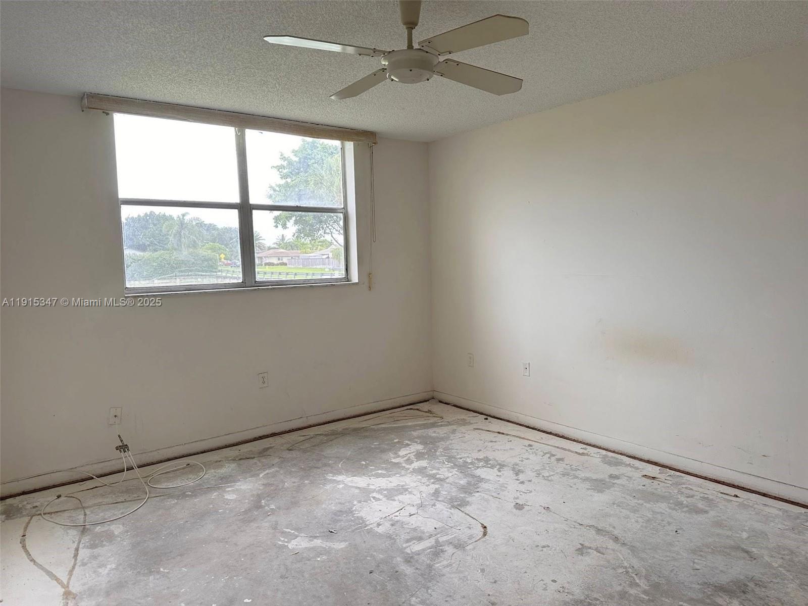 9090 Lime Bay Boulevard, Unit 106 Tamarac, FL 33321 - Photo 22 of 37 an empty room with a window