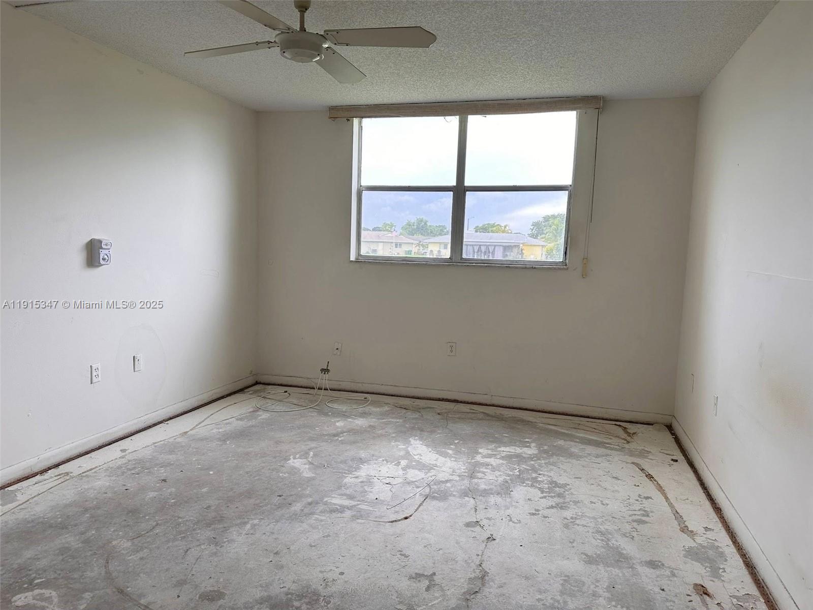 9090 Lime Bay Boulevard, Unit 106 Tamarac, FL 33321 - Photo 23 of 37 an empty room with a window