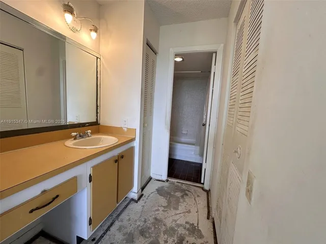 a view of a bathroom with a sink and a mirror