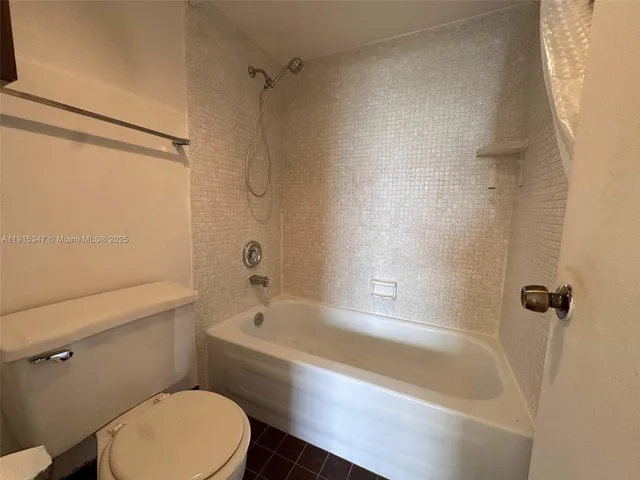 a white bath tub sitting next to a toilet