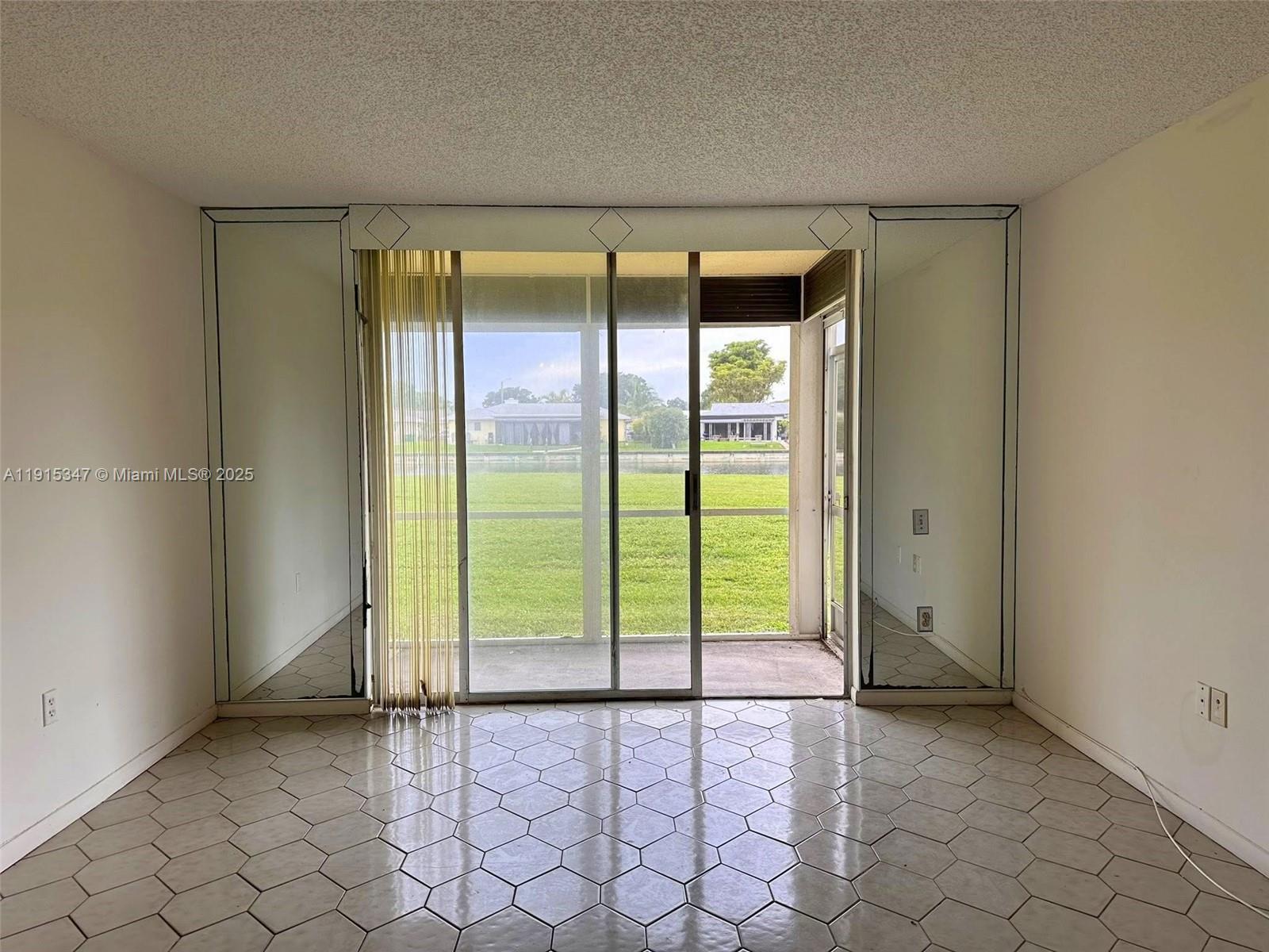 9090 Lime Bay Boulevard, Unit 106 Tamarac, FL 33321 - Photo 5 of 37 a view of an empty room and window