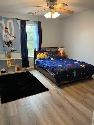 a bedroom with a bed and window