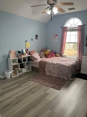 a bedroom with a bed and window
