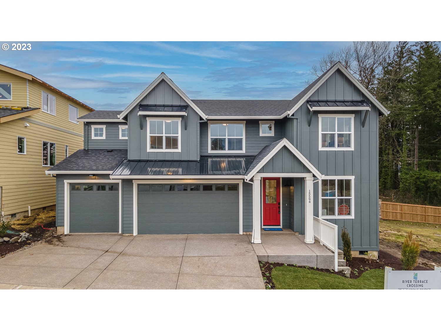 a house view with a garden and garage