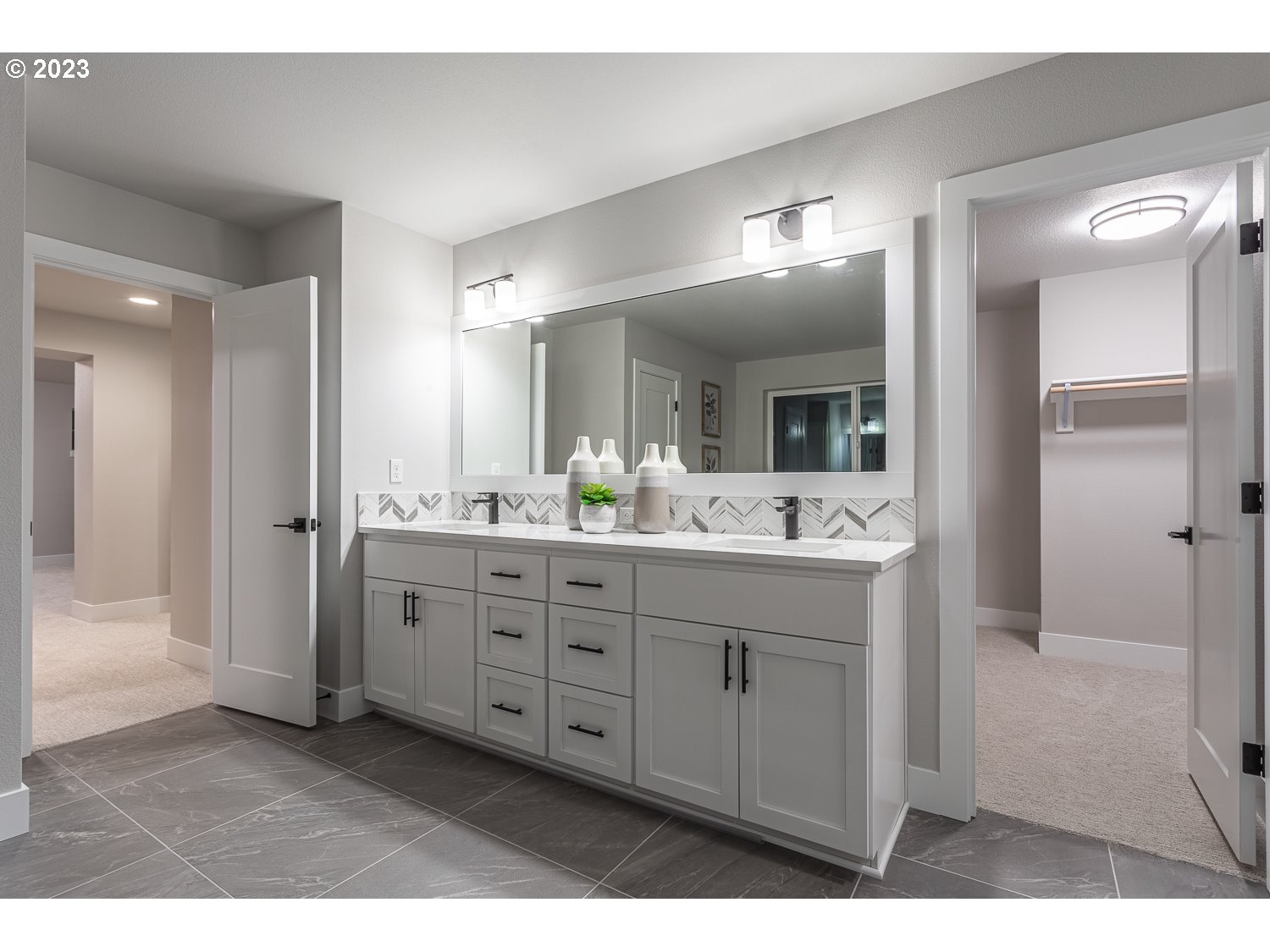 15594 Southwest Peace Avenue Tigard, OR 97224 - Photo 16 of 24 a spacious bathroom with a double vanity sink a mirror and a