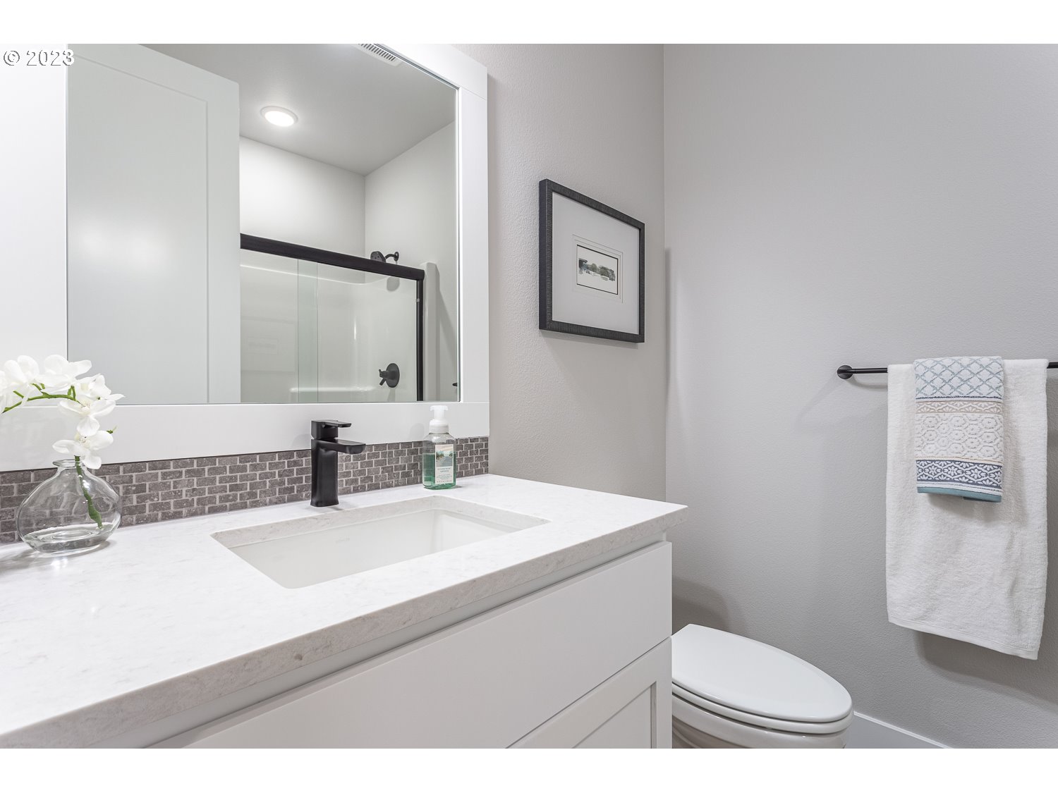 15594 Southwest Peace Avenue Tigard, OR 97224 - Photo 4 of 24 a bathroom with a sink toilet mirror and vanity