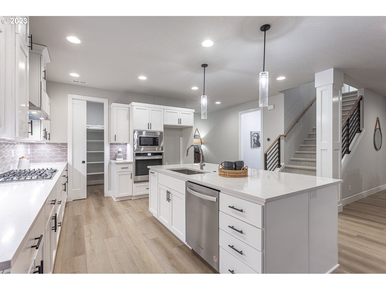 15594 Southwest Peace Avenue Tigard, OR 97224 - Photo 7 of 24 a kitchen with a sink a counter top space stainless steel appliances and a lots of counter top