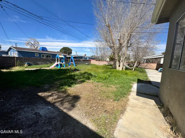 a view of a porch with furniture and garden