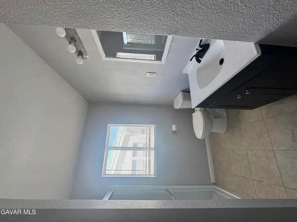 a view of a livingroom with a ceiling fan and window
