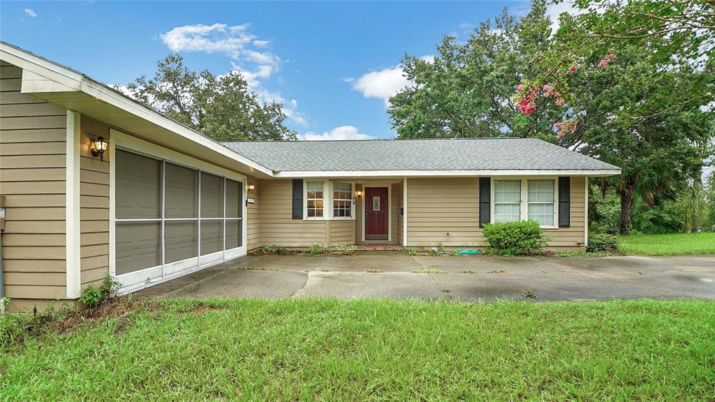 a front view of a house with a garden and yard
