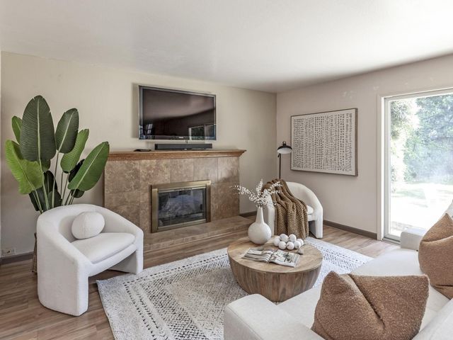 a living room with furniture and a fireplace