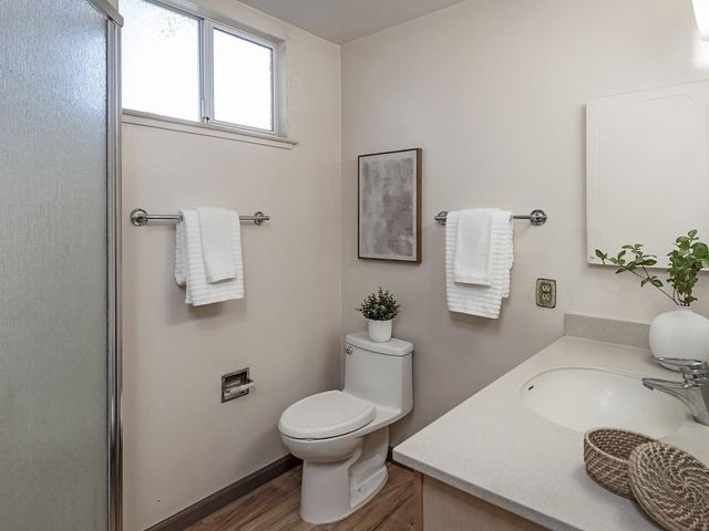 a bathroom with a toilet a sink and a mirror