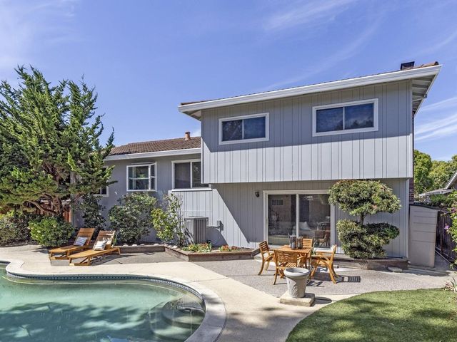 a house with swimming pool in front of it