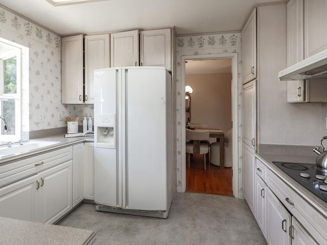 a kitchen with a refrigerator and a sink