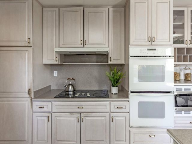 a kitchen with appliances cabinets and a counter top space