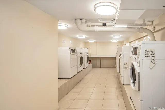 a view of a brick building next to a yard with big trees