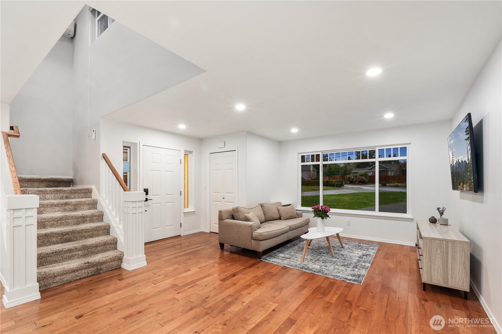 832 Harvest Road Bothell, WA 98012 - Photo 22 of 32 a living room with furniture and a flat screen tv