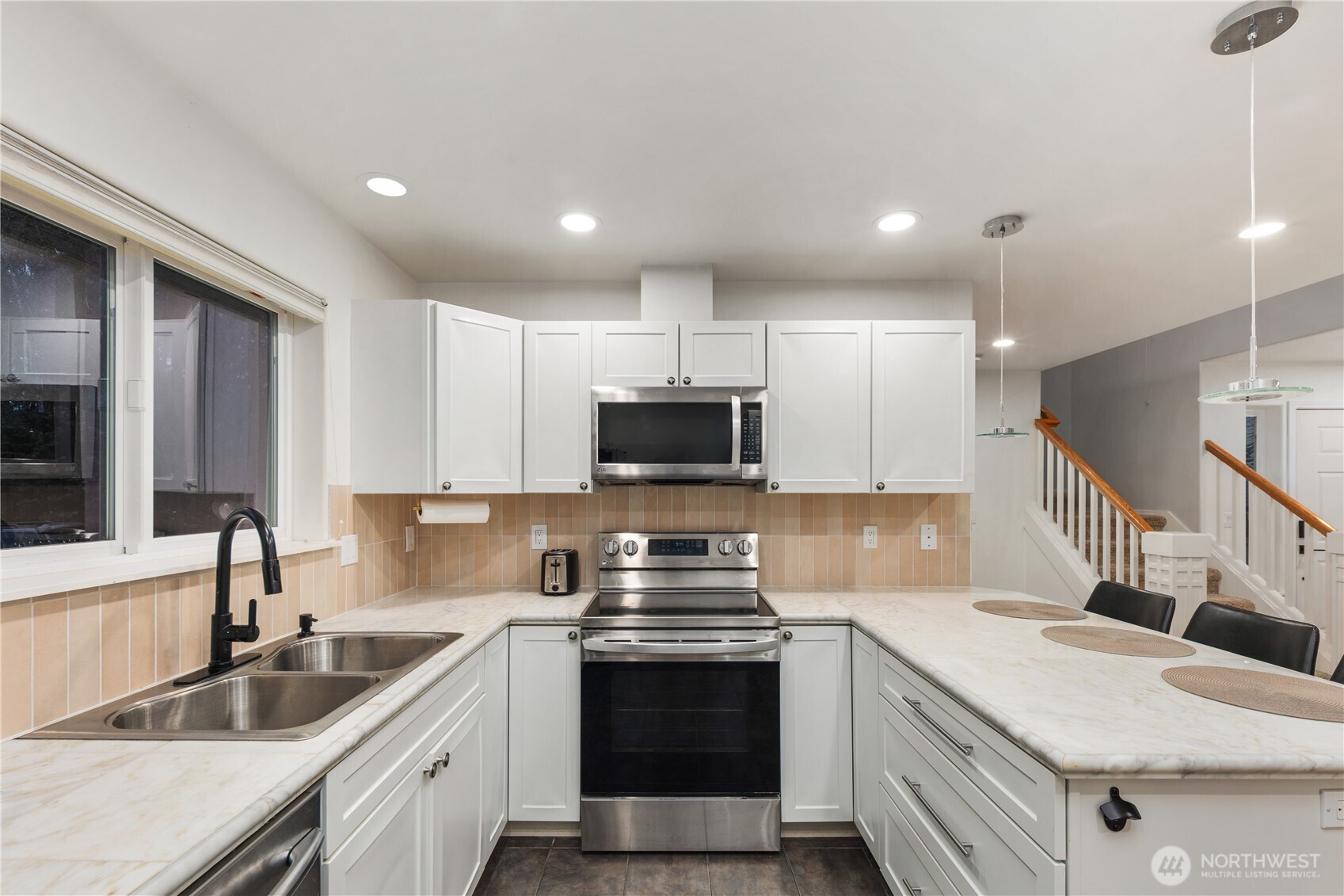 832 Harvest Road Bothell, WA 98012 - Photo 23 of 32 a kitchen with granite countertop a sink stainless steel appliances and white cabinets