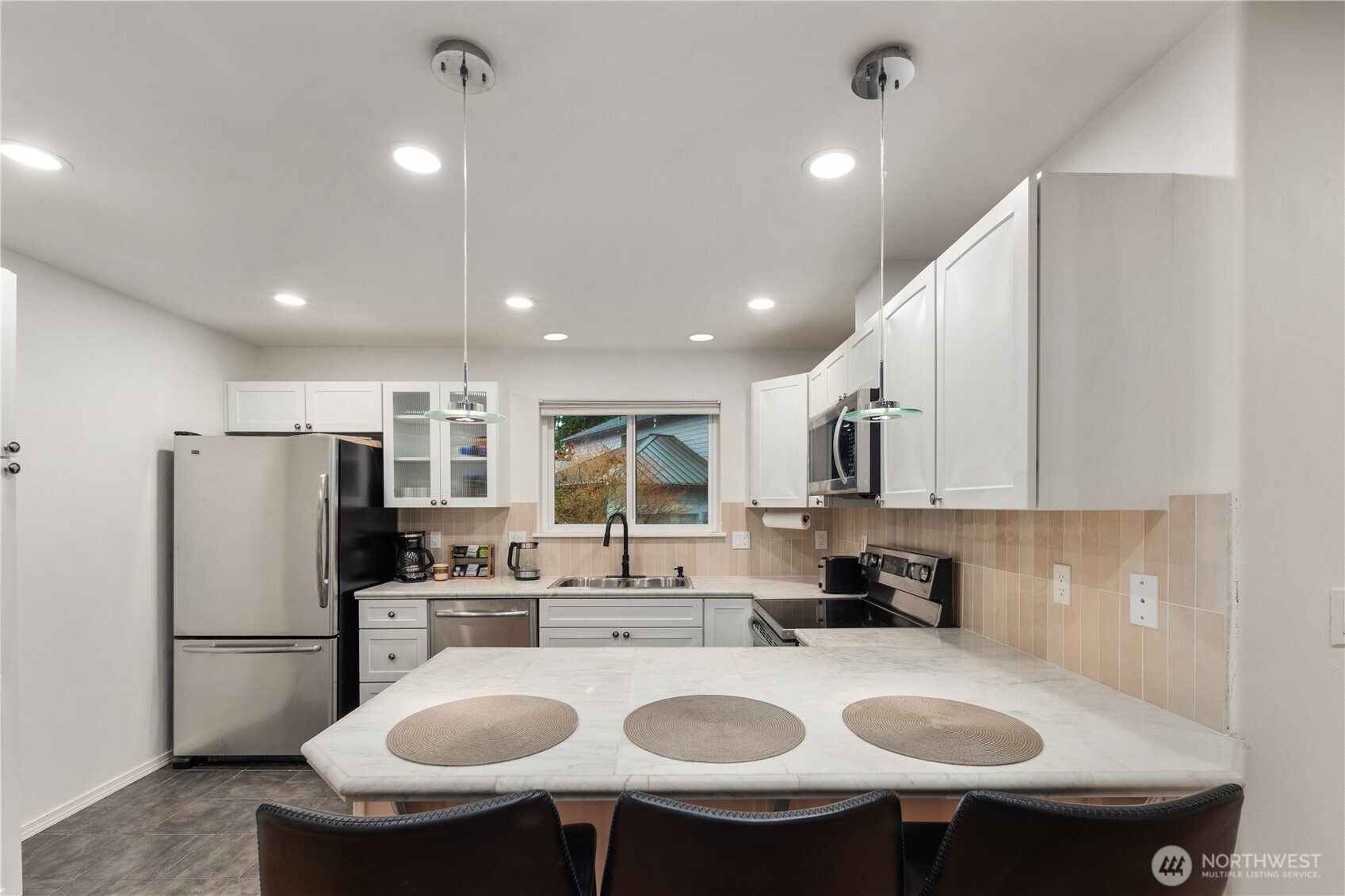 832 Harvest Road Bothell, WA 98012 - Photo 24 of 32 a kitchen with refrigerator a sink and white cabinets