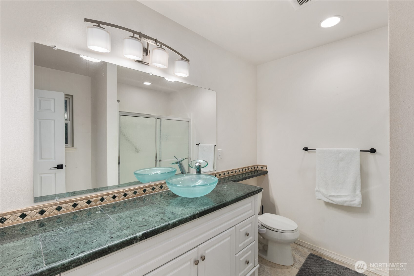 832 Harvest Road Bothell, WA 98012 - Photo 26 of 32 a bathroom with a granite countertop sink a toilet and a mirror