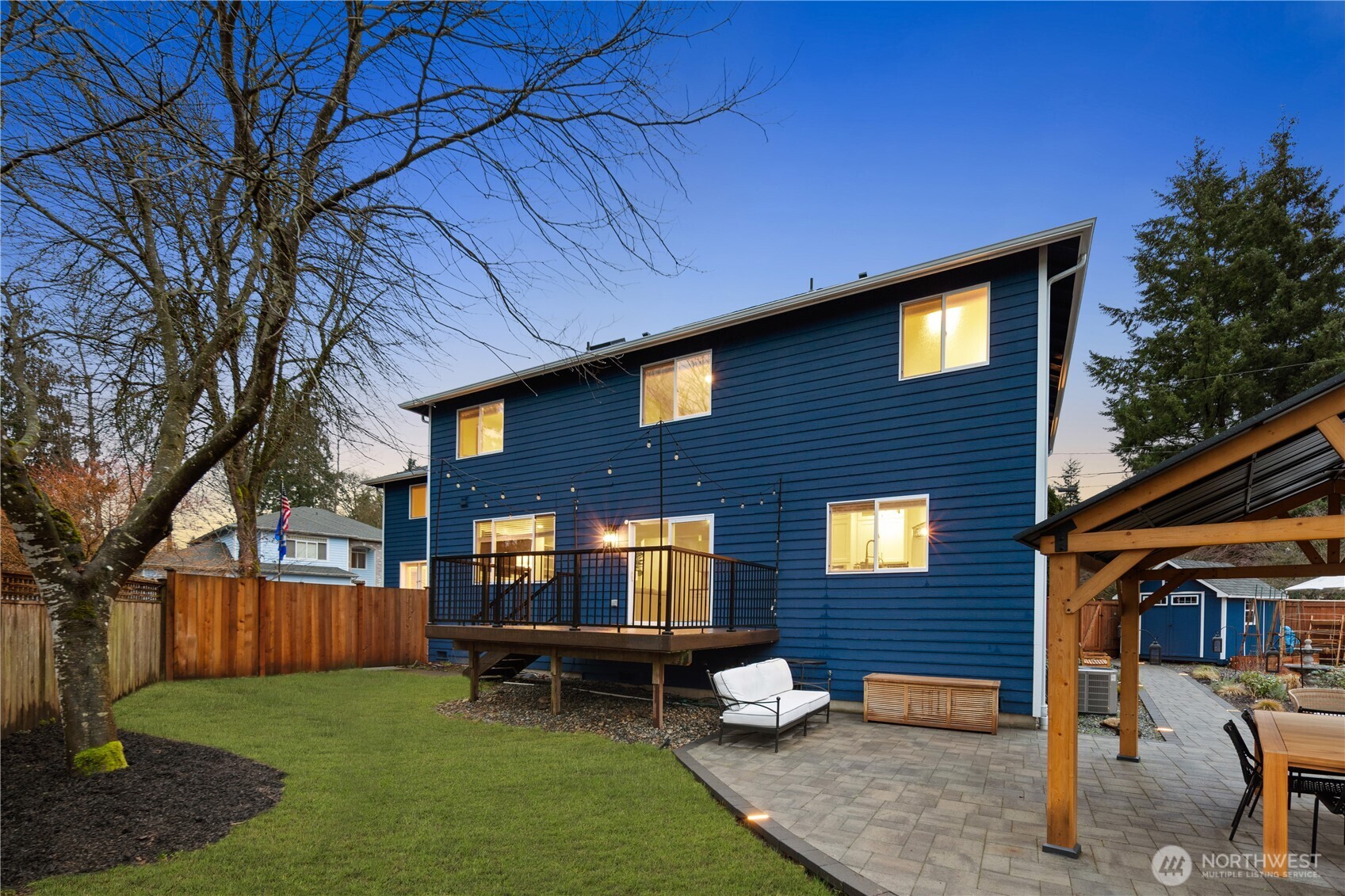 832 Harvest Road Bothell, WA 98012 - Photo 32 of 32 a backyard of a house with wooden fence and large trees