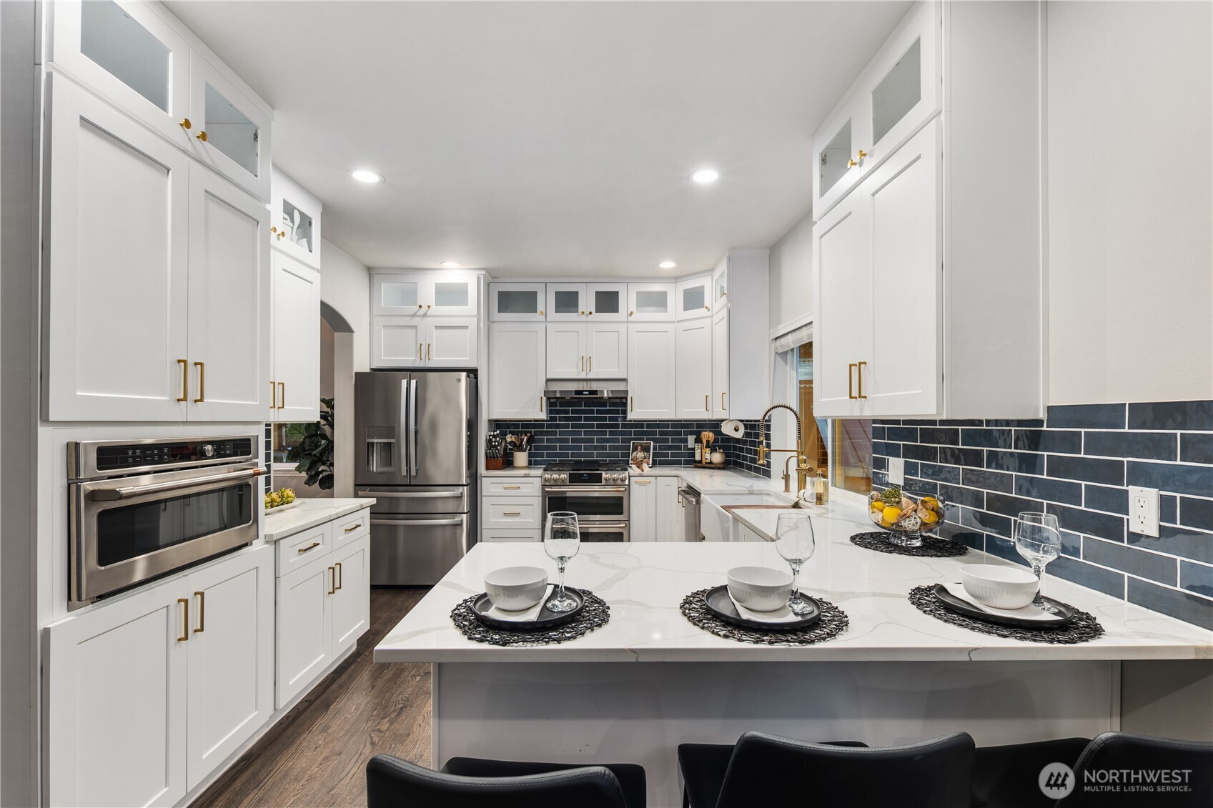 832 Harvest Road Bothell, WA 98012 - Photo 4 of 32 a kitchen with a refrigerator a stove a sink and cabinets