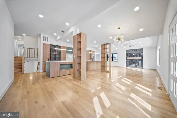 a kitchen with kitchen island a sink and a stove top oven