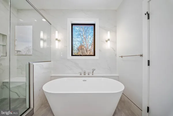 a bathroom with a bathtub and shower