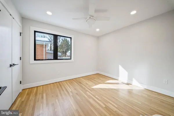 a view of empty room with wooden floor