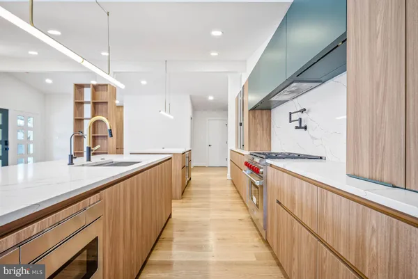 a stove top oven sitting inside of a kitchen
