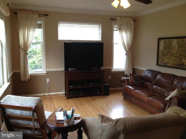 180 Walnut Creek Road Huntingtown, MD 20639 - Photo 4 of 6 a living room with furniture and a flat screen tv