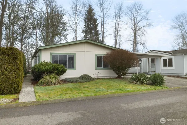 a front view of a house with a garden and yard