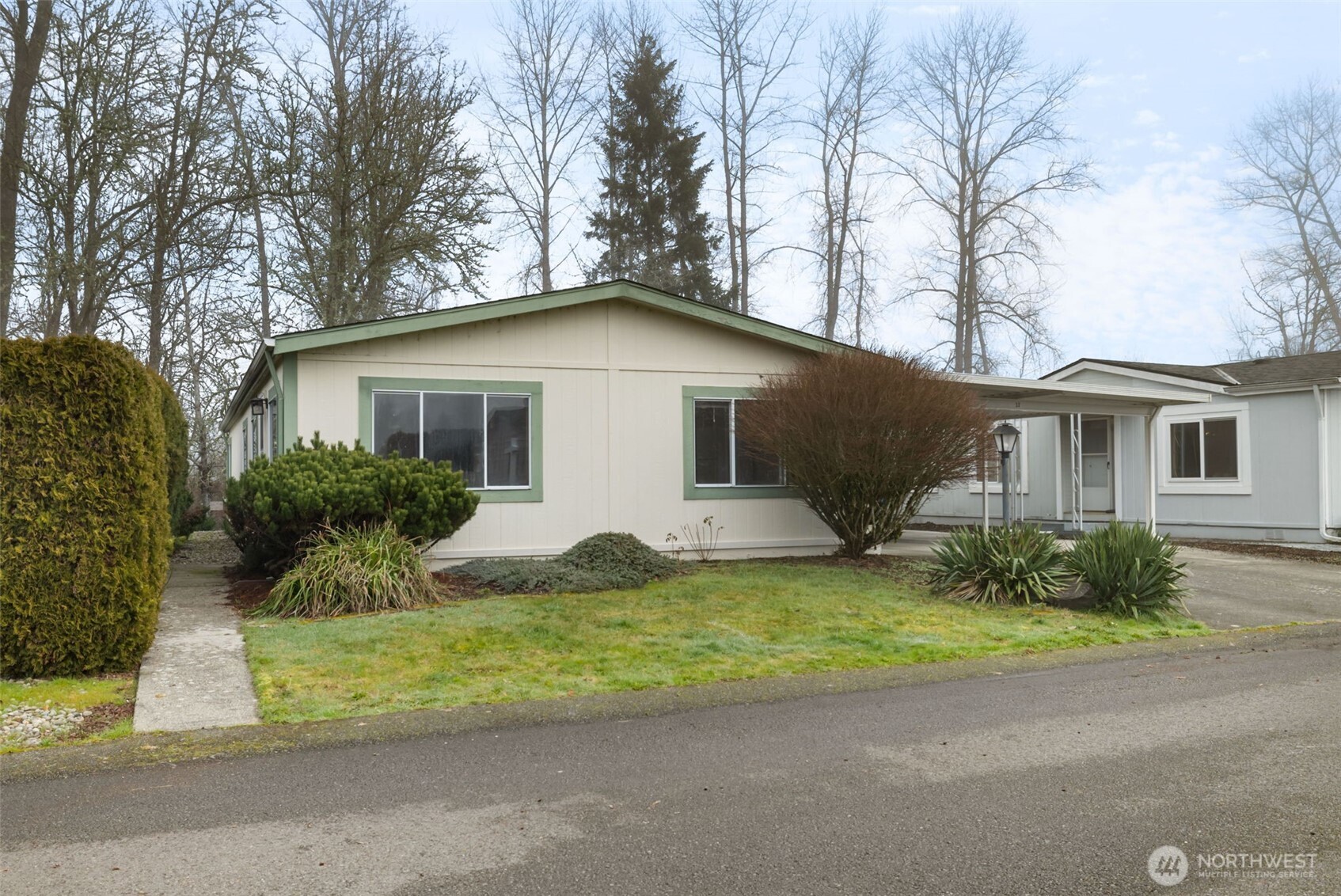 836 Harman Way South, Unit 33 Orting, WA 98360 - Photo 1 of 30 a front view of a house with a garden and yard